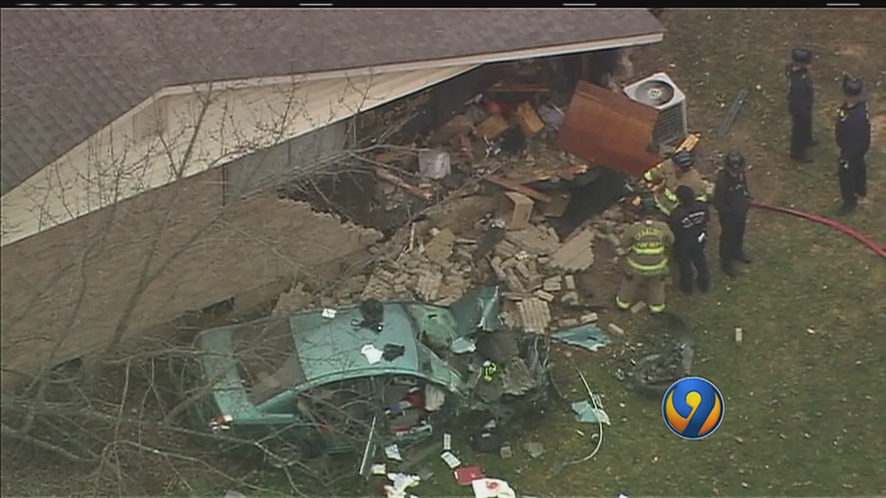 Car crashes into home in Charlotte, pinning one person inside