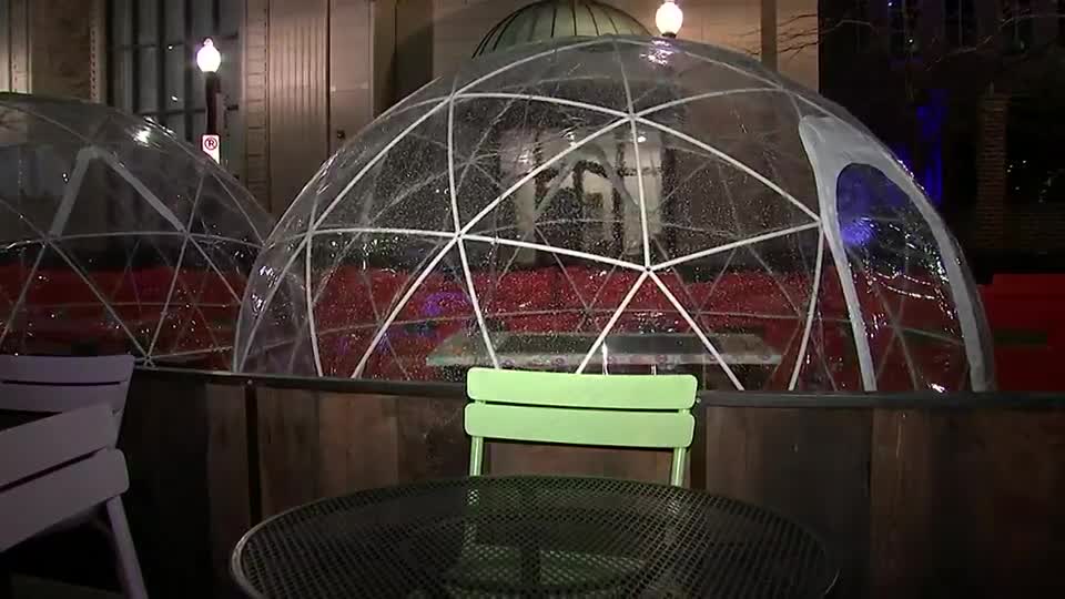 How safe is dining inside an enclosed outdoor tent at restaurants?