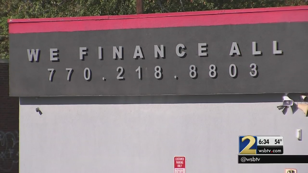 Cobb car dealership vows to get customers titles, tags after state raid